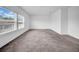 An empty bedroom with a large window and carpet at 13855 Sharp Hawk Dr, Riverview, FL 33569