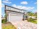 Charming two-story home with a brick driveway and well-manicured lawn at 13855 Sharp Hawk Dr, Riverview, FL 33569