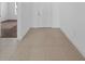 Clean foyer with beige tiled floors and a bright white front door entrance at 13855 Sharp Hawk Dr, Riverview, FL 33569