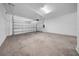 Spacious, empty two-car garage featuring concrete flooring and bright lighting at 13855 Sharp Hawk Dr, Riverview, FL 33569