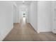 Bright hallway featuring neutral tile floors and white walls, creating a spacious feel at 13855 Sharp Hawk Dr, Riverview, FL 33569
