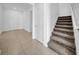 Hallway features stairwell and tile floors leading to carpeted areas at 13855 Sharp Hawk Dr, Riverview, FL 33569