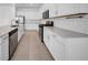 Bright kitchen features white cabinets, stainless steel appliances, and a subway tile backsplash at 13855 Sharp Hawk Dr, Riverview, FL 33569