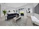 Bright living room featuring neutral walls, modern furniture, and large sliding doors to backyard at 13855 Sharp Hawk Dr, Riverview, FL 33569