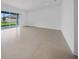 Bright living room features tile floors and large sliding glass doors to bring in plenty of light at 13855 Sharp Hawk Dr, Riverview, FL 33569