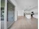 Open-concept living space with a modern kitchen, tile floors, and access to the outdoors at 13855 Sharp Hawk Dr, Riverview, FL 33569