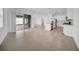 Spacious living area features tile floors, a modern kitchen, and access to outdoor living at 13855 Sharp Hawk Dr, Riverview, FL 33569