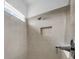 Bathroom shower featuring neutral tiles, a recessed niche, and a modern showerhead at 13855 Sharp Hawk Dr, Riverview, FL 33569