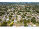 Suburban aerial view of a neighborhood highlighting a home with a pool and nearby park at 1398 Lemon St, Clearwater, FL 33756