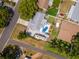 Aerial view of a home featuring a private pool, paved patio, and fenced yard at 1398 Lemon St, Clearwater, FL 33756
