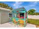 A vibrant outdoor bar with a colorful design, seating, and shade offers a unique entertainment space at 1398 Lemon St, Clearwater, FL 33756