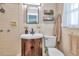 Cozy bathroom featuring a sink vanity, commode and shower with a light color tiled surround at 1398 Lemon St, Clearwater, FL 33756