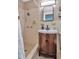 Cozy bathroom featuring a sink vanity, commode and shower with a light color tiled surround at 1398 Lemon St, Clearwater, FL 33756
