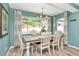 Bright dining room features a large window, coastal decor, and a charming chandelier for a welcoming space at 1398 Lemon St, Clearwater, FL 33756