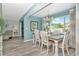 Dining area with a view of the pool area, coastal colors, and access to a cozy living space at 1398 Lemon St, Clearwater, FL 33756