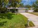 Charming single-story home featuring a well-maintained lawn and attached two-car garage at 1398 Lemon St, Clearwater, FL 33756