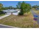 Street view of single-Gathering home with well manicured front yard with green grass and mature tree at 1398 Lemon St, Clearwater, FL 33756