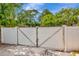 Gated entry to back yard with privacy fence and gravel driveway at 1398 Lemon St, Clearwater, FL 33756
