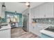 The bright, updated kitchen features white cabinets, stainless appliances, and stylish backsplash at 1398 Lemon St, Clearwater, FL 33756