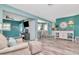 Open living space with wood-look floors, a cozy seating area, and a view into the dining area at 1398 Lemon St, Clearwater, FL 33756