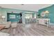 Spacious living room with wood-look floors, an open layout, and a dining area beyond at 1398 Lemon St, Clearwater, FL 33756