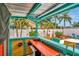 Outdoor tiki bar with sink, lighting, storage, and view of the pool and fenced yard at 1398 Lemon St, Clearwater, FL 33756