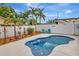 Beautiful private pool with turquoise Adirondack chairs, white fence, and tropical landscaping at 1398 Lemon St, Clearwater, FL 33756