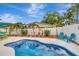 A beautiful pool with surrounding landscaping creates a peaceful backyard oasis at 1398 Lemon St, Clearwater, FL 33756