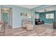 Relaxing sitting area with a comfortable armchair and ottoman, leading to a den at 1398 Lemon St, Clearwater, FL 33756