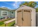 Backyard with large, modern, neutral-colored storage shed, and a convenient wooden bench at 1398 Lemon St, Clearwater, FL 33756