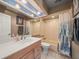 Neutral bathroom with a single vanity, a shower-tub combination, and decorative blue accents at 16015 Glen Haven Dr, Tampa, FL 33618