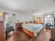Comfortable bedroom with hardwood floors, a ceiling fan, and curtains that let in plenty of natural light at 16015 Glen Haven Dr, Tampa, FL 33618
