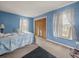 Comfortable bedroom with carpeted floors, natural light from the windows and a spacious closet at 16015 Glen Haven Dr, Tampa, FL 33618