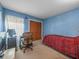 Comfortable bedroom with a built-in desk, carpeted floors, and ample storage space at 16015 Glen Haven Dr, Tampa, FL 33618