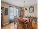 Traditional dining room with hardwood floors, a wooden table, and a stained-glass light fixture at 16015 Glen Haven Dr, Tampa, FL 33618