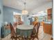 Cozy dining area featuring a round table and chairs, complemented by a kitchen with ample counter space and natural light at 16015 Glen Haven Dr, Tampa, FL 33618