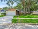 Charming single-story home featuring a well-maintained lawn and mature trees in a tranquil neighborhood at 16015 Glen Haven Dr, Tampa, FL 33618