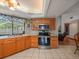 Traditional-style kitchen featuring stainless steel appliances and a bright window view at 16015 Glen Haven Dr, Tampa, FL 33618