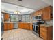 Bright kitchen featuring stainless steel appliances, wooden cabinets, and ample counter space for cooking at 16015 Glen Haven Dr, Tampa, FL 33618