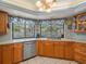 Well-lit kitchen with a window view to the backyard, featuring wood cabinetry at 16015 Glen Haven Dr, Tampa, FL 33618
