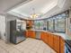 Spacious kitchen equipped with stainless steel appliances, abundant cabinetry, and tiled flooring at 16015 Glen Haven Dr, Tampa, FL 33618