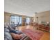 Spacious living room with a red rug, traditional furniture and large windows at 16015 Glen Haven Dr, Tampa, FL 33618