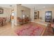 Open-concept living room with hardwood floors, area rug, and traditional decor at 16015 Glen Haven Dr, Tampa, FL 33618