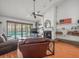 Cozy living room with fireplace and sliding glass doors leading to a pool area at 16015 Glen Haven Dr, Tampa, FL 33618