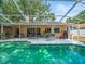 Serene screened-in pool area with plenty of seating, perfect for leisurely afternoons and Gathering gatherings at 16015 Glen Haven Dr, Tampa, FL 33618
