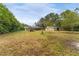 Expansive backyard with outbuildings and screened patio creating a private outdoor retreat at 1609 S Valrico Rd, Valrico, FL 33594