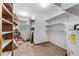 Basement with shelving, a water heater, and a window providing natural light at 1609 S Valrico Rd, Valrico, FL 33594