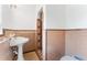 A cozy bathroom featuring a pedestal sink and a tiled shower at 1609 S Valrico Rd, Valrico, FL 33594
