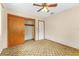 Bedroom with a ceiling fan, closet, and carpeted floor at 1609 S Valrico Rd, Valrico, FL 33594
