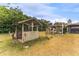 A custom-built wooden gazebo adds character to the spacious backyard, perfect for outdoor enjoyment at 1609 S Valrico Rd, Valrico, FL 33594